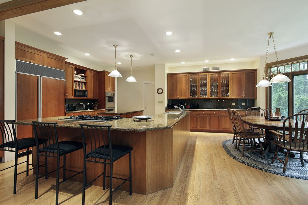 A close up of a kitchen with an L-shaped island